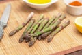 Bunch of green fresh asparagus for cooking on wooden table on kitchen close up. Healthy vegan food concept Royalty Free Stock Photo