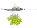 Bunch of green grapes falling into water, with a splash