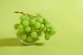 A bunch of green grapes in a glass bowl on a colored background Royalty Free Stock Photo