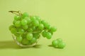 A bunch of green grapes in a glass bowl on a colored background Royalty Free Stock Photo