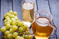 Bunch of green grapes and juice in the glass, pitcher