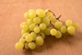 Bunch green grapes on wooden background. Royalty Free Stock Photo