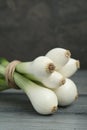 Bunch of green spring onions on grey wooden table, closeup Royalty Free Stock Photo