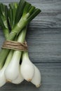 Bunch of green spring onions on grey wooden table, flat lay Royalty Free Stock Photo