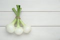 Bunch of green spring onions on white wooden table, flat lay. Space for text Royalty Free Stock Photo