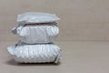 A bunch of grey post packages from Chinese stores close up on a grey background