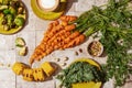 Bunch of grilled carrot roots with green leaves, Brussels sprouts on green craft plate, salad leaves, nuts, apricot jam grilled co