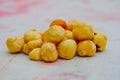 A bunch of hazelnuts, round shaped snack fruit, natural energy bar. Healthy nuts cream color, trail mix on table