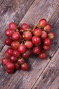 A bunch of juicy large red grapes on a table of dark old wooden Royalty Free Stock Photo