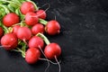 A bunch of juicy red radishes Healthy food, on black stone background, with copy space for text Royalty Free Stock Photo