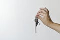 Bunch of keys in a female hand on a light background. new life. Royalty Free Stock Photo