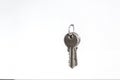 A bunch of keys hanging on a nail isolated against a white backg
