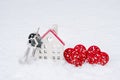 A bunch of keys of house and two hearts in snow - Valentine`s Day, love in home. Couple housing, real estate, rent, mortgage, rel Royalty Free Stock Photo