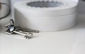 Bunch of keys resting on a white-plated wooden cabinet