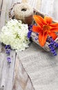Bunch of lavender flowers and lily in basket on an old wood tab Royalty Free Stock Photo