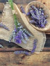 bunch of lavender flowers on piece of fabric and basket on table