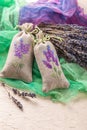 Bunch of lavender flowers and sachets filled with dried lavender. Royalty Free Stock Photo