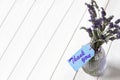 Bunch of lavender in a glass lantern jar, with thank you written on a blue gift label.