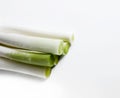 A bunch of leeks piled on a white table Royalty Free Stock Photo