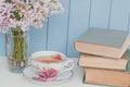 Bunch of lilac, books and teacup