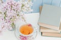 Bunch of lilac, books and teacup Royalty Free Stock Photo