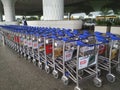 A bunch of luggage trolley with wheels and basket to carry goods and products. Empty shopping cart on an airport terminal and mal