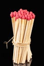 A bunch of matches with red heads isolated on a black background, close up Royalty Free Stock Photo