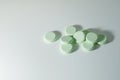 A bunch of medicinal pills and antibiotics, White medical tablets, light green, with copy space