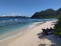 A bunch of men sitting idly by the beach in banda aceh Royalty Free Stock Photo