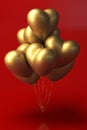 Bunch of metallic gold color heart shaped foil balloons on red background. Royalty Free Stock Photo