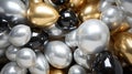 A bunch of metallic, reflective balloons in gold and silver shades