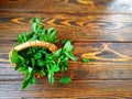 bunch of mint in a small wicker basket on old burnt wooden background Royalty Free Stock Photo