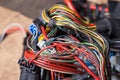 A bunch of multi-colored electrical wires interconnected in the nodes of a car during network repair by an engineer or mechanic in