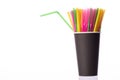 Bunch of multi colored plastic straws in black disposable biodegradable cup Royalty Free Stock Photo