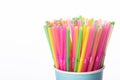 Multi colored plastic straws in disposable paper cup isolated on white backdrop Royalty Free Stock Photo