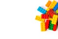 Lego background. Bunch of many Colorful Plastick constructor bricks on white background. Popular toys. Copyspace