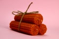 bunch of natural handmade candles made of wax on a pink background Royalty Free Stock Photo