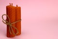 bunch of natural handmade candles made of wax on a pink background. Space for text Royalty Free Stock Photo