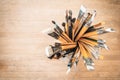 Bunch of old artist paintbrushes in glass on wooden rustic table with space for text