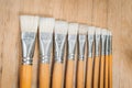 Bunch of old artist paintbrushes on wooden rustic table