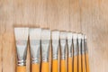 Bunch of old artist paintbrushes on wooden rustic table