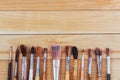 Bunch of old artist paintbrushes on wooden rustic table