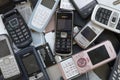 Bunch of old used outdated mobile phones and batteries. Recycling electronics Royalty Free Stock Photo