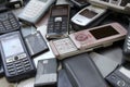 Bunch of old used outdated mobile phones and batteries. Recycling electronics Royalty Free Stock Photo