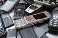 Bunch of old used outdated mobile phones and batteries. Recycling electronics Royalty Free Stock Photo