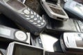 Bunch of old used outdated mobile phones. Recycling electronics in the market cheap Royalty Free Stock Photo