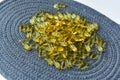 Bunch of omega 3 fish liver oil capsules in pile. Close up of big golden translucent pills texture. Healthy every day nutritional