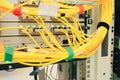 A bunch of optical Internet cables connected to the main router. Powerful network equipment located in the server room datacenter