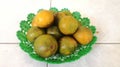 Bunch Oranges fruit ripe on a green plastic plate, in the room Royalty Free Stock Photo