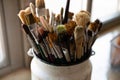 Bunch of paint brushes in metal bucket close up